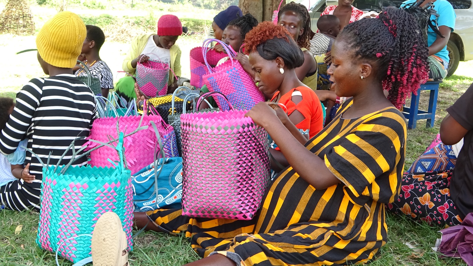 A young mother weaves a basket during vocational skills training.