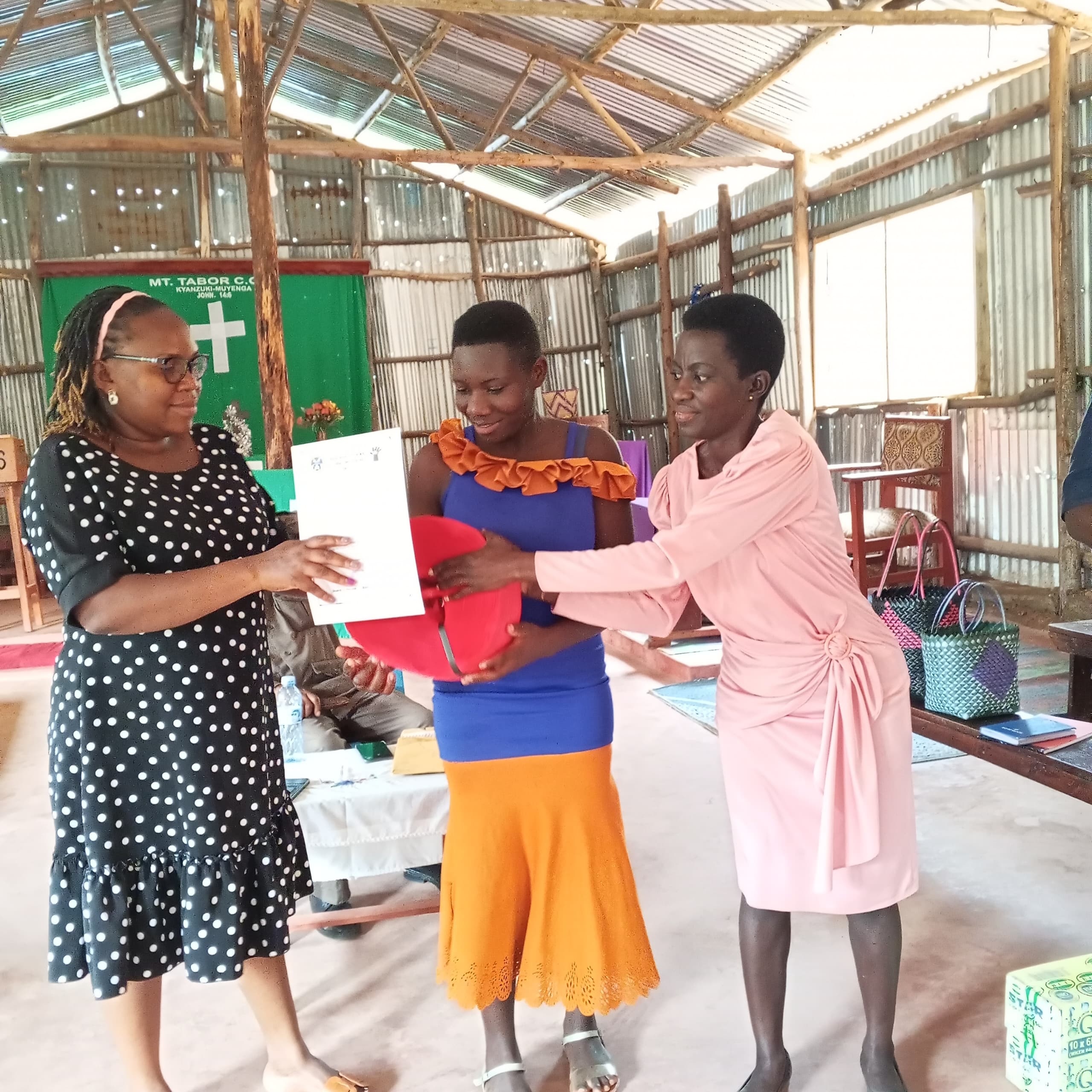 Robina receiving her certificate and startup kit at graduation.