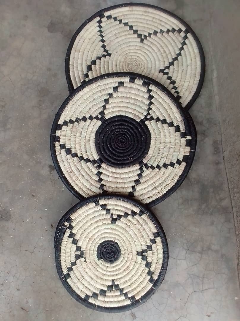 Handwoven mats displayed together.