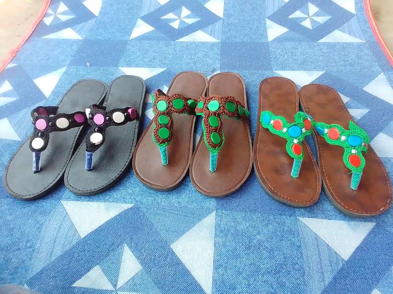 Handmade shoes displayed on a table.