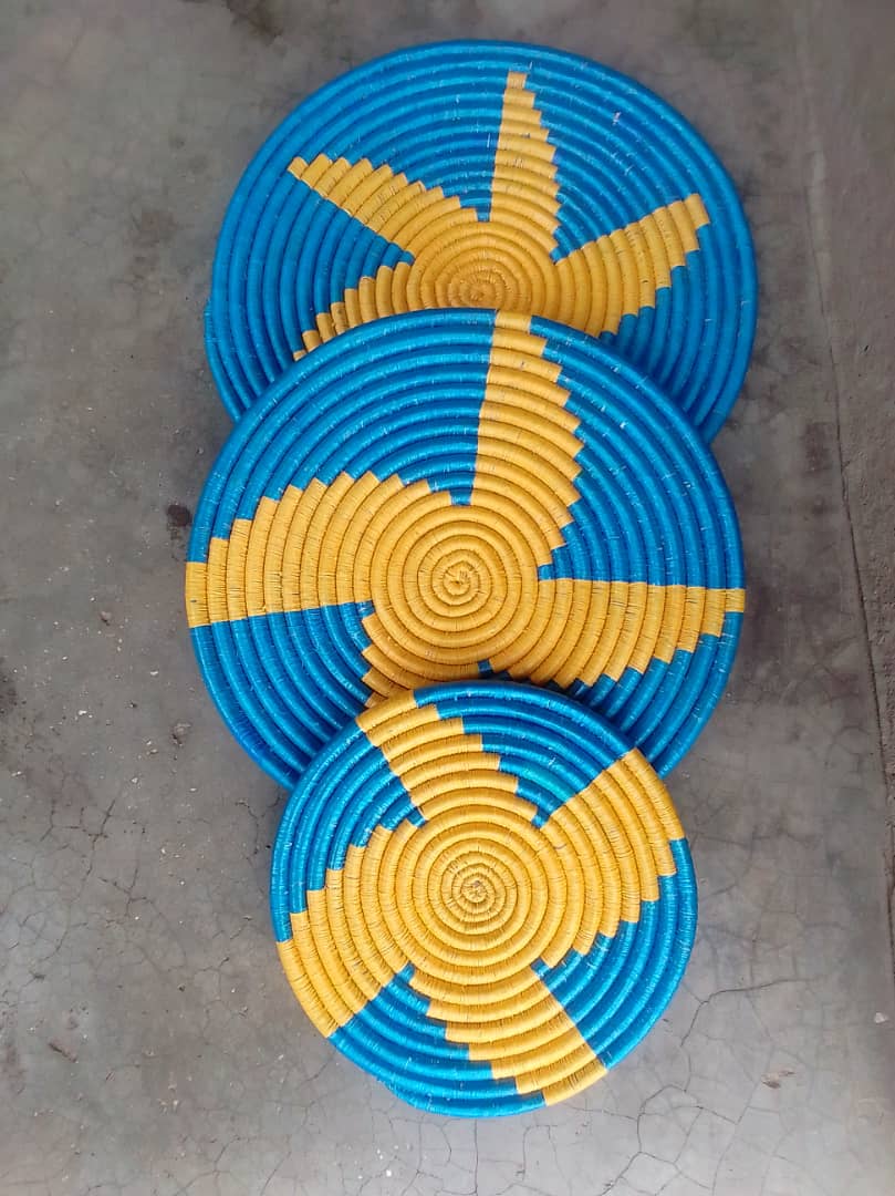 Colorful woven mats displayed together.